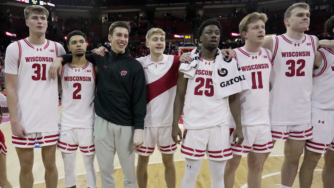 Wisconsin forward Nolan Winter (31), guard Nick Boyd (2), injured guard Jack Janicki, guard Isaac Gard, guard John Blackwell (25), forward Jack Robison (11) and forward Aleksas Bieliauskas (32) are shown during the signing of Varsity after their game Sunday, February 22, 2026 at the Kohl Center in Madison, Wisconsin. Wisconsin beat Iowa 84-71.
