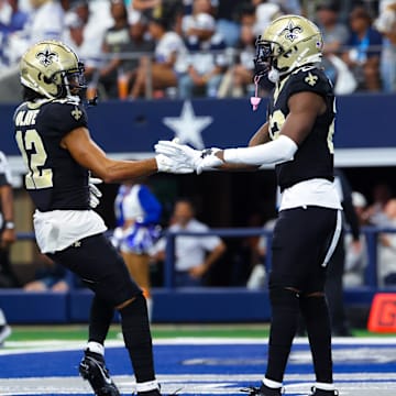 Sep 15, 2024; Arlington, Texas, USA;  New Orleans Saints wide receiver Rashid Shaheed (22) celebrates with New Orleans Saints wide receiver Chris Olave (12) after catching a touchdown  pass during the first quarter against the Dallas Cowboys at AT&T Stadium. Mandatory Credit: Kevin Jairaj-Imagn Images