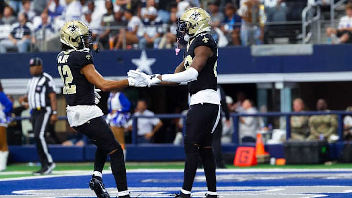 Sep 15, 2024; Arlington, Texas, USA;  New Orleans Saints wide receiver Rashid Shaheed (22) celebrates with New Orleans Saints wide receiver Chris Olave (12) after catching a touchdown  pass during the first quarter against the Dallas Cowboys at AT&T Stadium. Mandatory Credit: Kevin Jairaj-Imagn Images