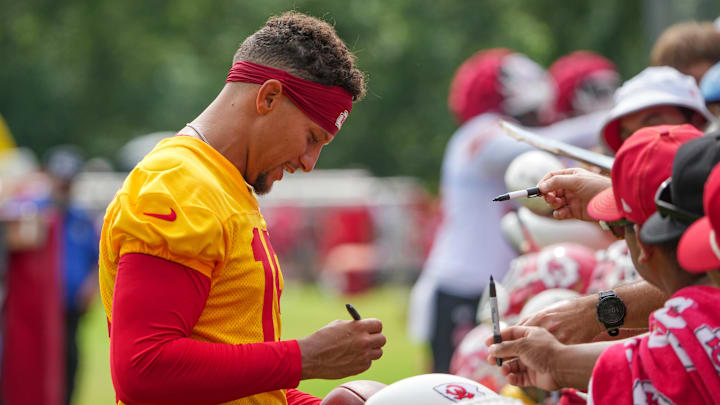 Kansas City Chiefs quarterback Patrick Mahomes  signs autographs for fans after training camp