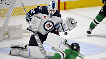 Apr 11, 2024; Dallas, Texas, USA; Winnipeg Jets goaltender Laurent Brossoit (39) stops a shot by Dallas Stars center Tyler Seguin (91) during the third period at the American Airlines Center. Mandatory Credit: Jerome Miron-Imagn Images