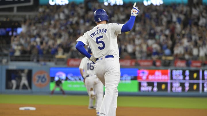 Jul 19, 2024; Los Angeles, California, USA;  Los Angeles Dodgers first base Freddie Freeman (5) celebrates after hitting a grand slam home run in the eighth inning against the Boston Red Sox at Dodger Stadium. Mandatory Credit: Jayne Kamin-Oncea-USA TODAY Sports