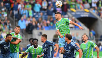 Sep 15, 2024; Seattle, Washington, USA; Seattle Sounders midfielder Cristian Roldan (7) heads the ball in the second half against the Sporting Kansas City at Lumen Field. Mandatory Credit: Steven Bisig-Imagn Images