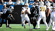 Nov 9, 2025; Charlotte, North Carolina, USA; New Orleans Saints quarterback Tyler Shough (6) looks to pass during the second quarter against the Carolina Panthers at Bank of America Stadium. Mandatory Credit: Bob Donnan-Imagn Images