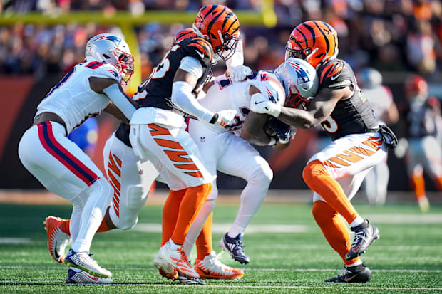 New England Patriots running back TreVeyon Henderson (32) is wrapped up on a carry in the second quarter of the NFL Week 12 g