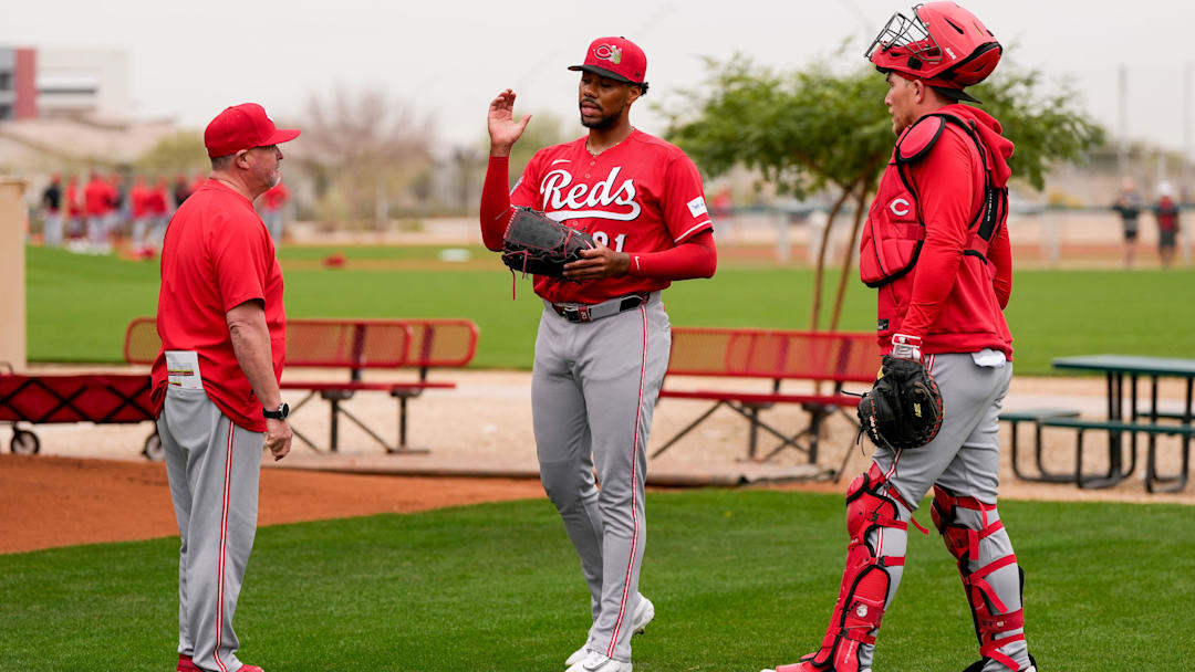 Cincinnati Reds pitching coach/director of pitching Derek Johnson (36) wraps up a bullpen session with pitcher Hunter Greene (21) at the Cincinnati Reds player development complex in Goodyear, Ariz., on Friday, Feb. 13, 2026.