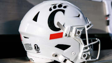 Oct 18, 2025; Stillwater, Oklahoma, USA; Cincinnati Bearcats helmet sits on the bench prior to the game against the Oklahoma State Cowboys at Boone Pickens Stadium. Mandatory Credit: William Purnell-Imagn Images
