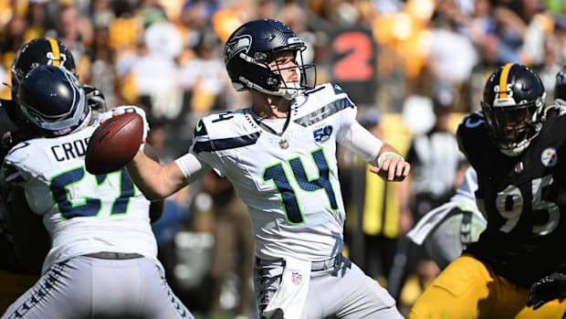 Seahawks quarterback Sam Darnold (14) throws a pass while being pressured by Steelers defensive tackle Keeanu Benton
