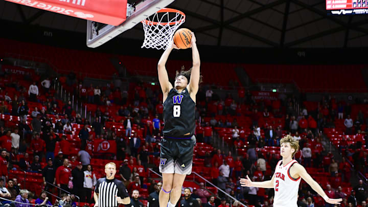 Dec 31, 2023; Salt Lake City, Utah, USA; Washington Huskies guard Nate Calmese (8) dunks over Utah Utes guard Cole Bajema (2) during the second half at the the Jon M. Huntsman Center. Mandatory Credit: Christopher Creveling-Imagn Images