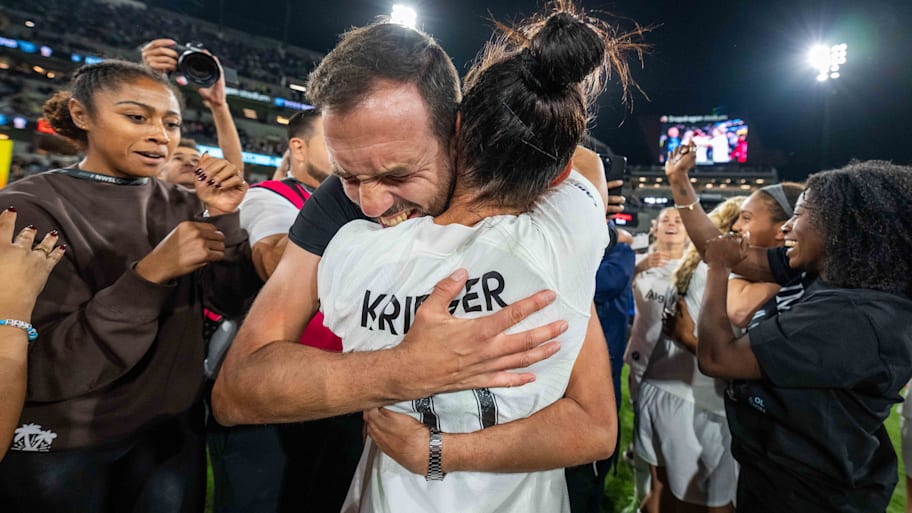 Ali Krieger and head coach Juan Carlos Amoros celebrate after the NWSL Championship match against OL Reign at Snapdragon
