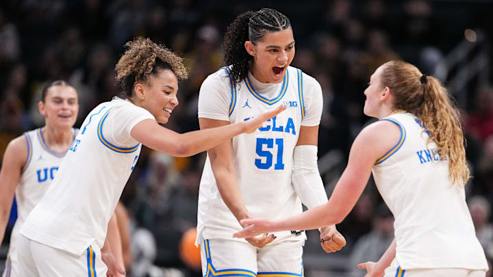 UCLA Bruins center Lauren Betts (51) and UCLA Bruins guard Kiki Rice (1) high-five UCLA Bruins guard Gianna Kneepkens (8) on Sunday, March 8, 2026, during the Big Ten Tournament Championship game at Gainbridge Fieldhouse in Indianapolis. UCLA Bruins defeated the Iowa Hawkeyes, 96-45, for back to back Big Ten championships.