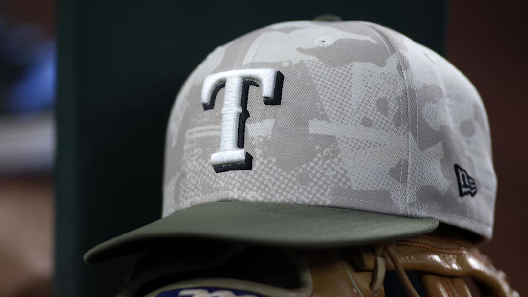 May 18, 2025; Arlington, Texas, USA;  Texas Rangers hat in honor of the military in the dugout  during the second inning against the Houston Astros at Globe Life Field. 