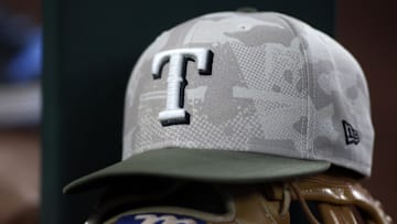 May 18, 2025; Arlington, Texas, USA;  Texas Rangers hat in honor of the military in the dugout  during the second inning against the Houston Astros at Globe Life Field.