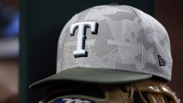 May 18, 2025; Arlington, Texas, USA;  Texas Rangers hat in honor of the military in the dugout  during the second inning against the Houston Astros at Globe Life Field. 
