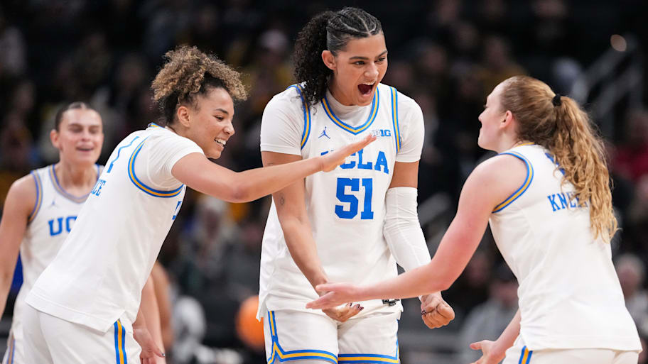 center Lauren Betts (51) and UCLA Bruins guard Kiki Rice (1) high-five UCLA Bruins guard Gianna Kneepkens (8) 