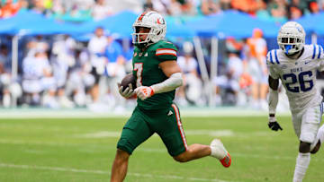 Nov 2, 2024; Miami Gardens, Florida, USA; Miami Hurricanes wide receiver Xavier Restrepo (7) runs with the football for a touchdown against the Duke Blue Devils during the fourth quarter at Hard Rock Stadium. Mandatory Credit: Sam Navarro-Imagn Images