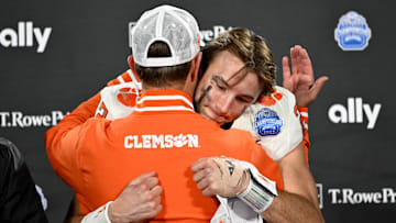 Dec 7, 2024; Charlotte, NC, USA; Clemson Tigers head coach Dabo Swinney, and quarterback Cade Klubnik (2) celebrate after winning the 2024 ACC Championship game against the Southern Methodist Mustangs at Bank of America Stadium. Mandatory Credit: Bob Donnan-Imagn Images