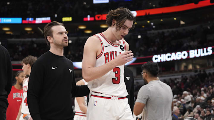 Dec 29, 2025; Chicago, Illinois, USA; A trainer helps Chicago Bulls guard Josh Giddey (3) off the court during the second half at United Center. Mandatory Credit: David Banks-Imagn Images
