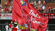 Aug 18, 2022; St. Louis, Missouri, USA;  St. Louis Cardinals mascot Fredbird runs on the field with a Cardinals flag after the Cardinals defeated the Colorado Rockies at Busch Stadium. Mandatory Credit: Jeff Curry-Imagn Images