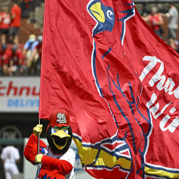 Aug 18, 2022; St. Louis, Missouri, USA;  St. Louis Cardinals mascot Fredbird runs on the field with a Cardinals flag after the Cardinals defeated the Colorado Rockies at Busch Stadium. Mandatory Credit: Jeff Curry-Imagn Images