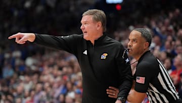 Jan 25, 2025; Lawrence, Kansas, USA; An official restrains Kansas Jayhawks head coach Bill Self against the Houston Cougars during overtime at Allen Fieldhouse. Mandatory Credit: Denny Medley-Imagn Images