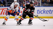 Nov 1, 2024; Buffalo, New York, USA;  New York Islanders center Brock Nelson (29) and Buffalo Sabres left wing Jordan Greenway (12) go after a loose puck during the first period at KeyBank Center. Mandatory Credit: Timothy T. Ludwig-Imagn Images