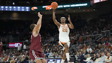 Dec 12, 2024; Austin, Texas, USA; Texas Longhorns guard Tre Johnson (20) passes the ball for an alley-oop over New Mexico State Aggies forward Peter Filipovity (12) during the second half at Moody Center. Mandatory Credit: Scott Wachter-Imagn Images