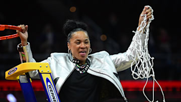 Apr 7, 2024; Cleveland, OH, USA; South Carolina Gamecocks head coach Dawn Staley cuts the net after defeating the Iowa Hawkeyes in the finals of the Final Four of the womens 2024 NCAA Tournament  at Rocket Mortgage FieldHouse. Mandatory Credit: Ken Blaze-Imagn Images