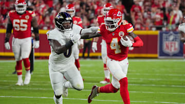 Sep 5, 2024; Kansas City, Missouri, USA; Kansas City Chiefs wide receiver Rashee Rice (4) runs the ball as Baltimore Ravens linebacker Roquan Smith (0) defends during the first half at GEHA Field at Arrowhead Stadium. Mandatory Credit: Denny Medley-Imagn Images