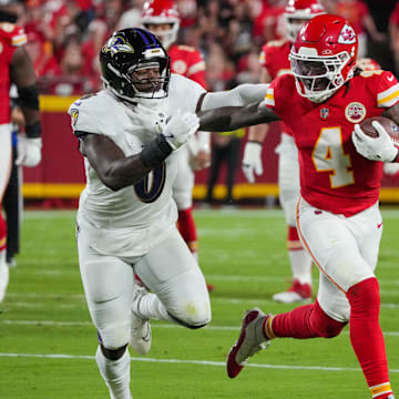 Sep 5, 2024; Kansas City, Missouri, USA; Kansas City Chiefs wide receiver Rashee Rice (4) runs the ball as Baltimore Ravens linebacker Roquan Smith (0) defends during the first half at GEHA Field at Arrowhead Stadium. Mandatory Credit: Denny Medley-Imagn Images