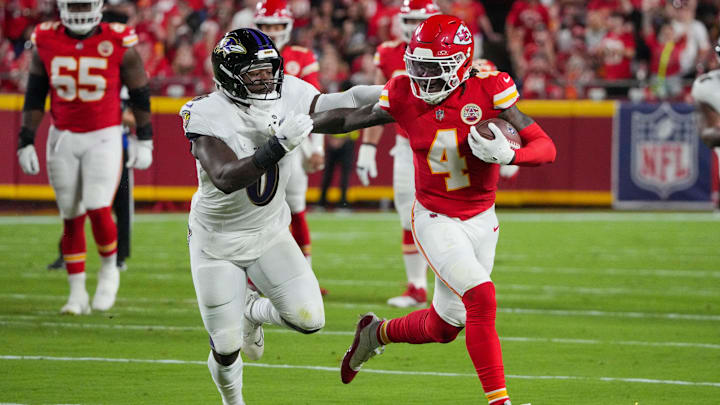 Sep 5, 2024; Kansas City, Missouri, USA; Kansas City Chiefs wide receiver Rashee Rice (4) runs the ball as Baltimore Ravens linebacker Roquan Smith (0) defends during the first half at GEHA Field at Arrowhead Stadium. Mandatory Credit: Denny Medley-Imagn Images