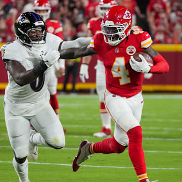 Sep 5, 2024; Kansas City, Missouri, USA; Kansas City Chiefs wide receiver Rashee Rice (4) runs the ball as Baltimore Ravens linebacker Roquan Smith (0) defends during the first half at GEHA Field at Arrowhead Stadium. Mandatory Credit: Denny Medley-Imagn Images