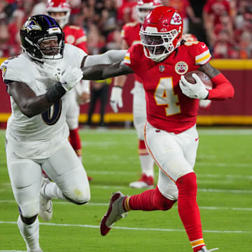 Kansas City Chiefs wide receiver Rashee Rice (4) runs the ball as Baltimore Ravens linebacker Roquan Smith (0) defends during the first half at GEHA Field at Arrowhead Stadium. 