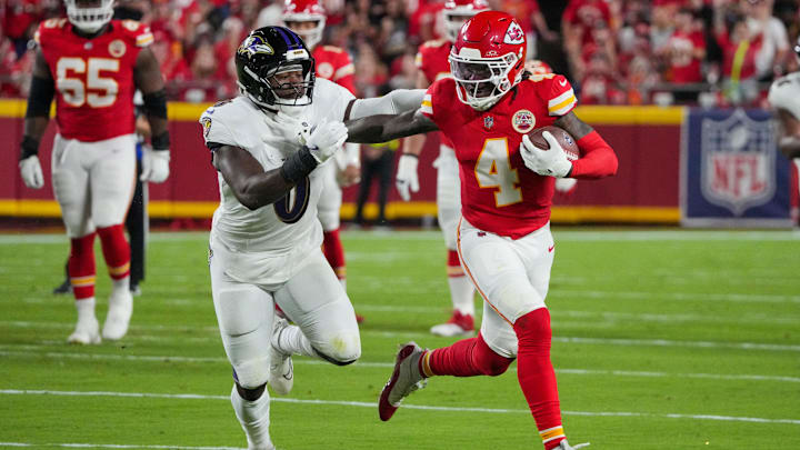 Kansas City Chiefs wide receiver Rashee Rice (4) runs the ball as Baltimore Ravens linebacker Roquan Smith (0) defends during the first half at GEHA Field at Arrowhead Stadium. 