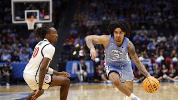Mar 18, 2025; Dayton, OH, USA; North Carolina Tar Heels guard Elliot Cadeau (3) dribbles the ball defended by San Diego State Aztecs guard BJ Davis (10) in the second half at UD Arena. Mandatory Credit: Rick Osentoski-Imagn Images