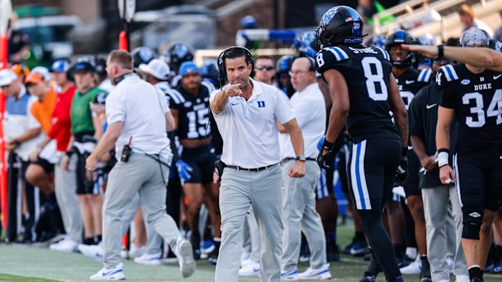 Sep 28, 2024; Durham, North Carolina, USA;  Duke Blue Devils head coach Manny Diaz reacts to wide receiver Jordan Moore (8) during the first half of the game against North Carolina Tar Heels at Wallace Wade Stadium. Mandatory Credit: Jaylynn Nash-Imagn Images