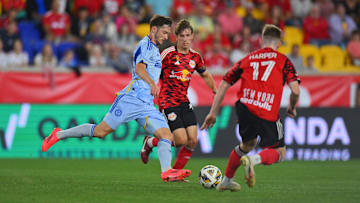 Sep 21, 2024; Harrison, New Jersey, USA; Atlanta United midfielder Alexey Miranchuk (59) controls the ball against New York Red Bulls midfielder Daniel Edelman (75) and New York Red Bulls defender Cameron Harper (17) during the first half at Red Bull Arena. Mandatory Credit: John Jones-Imagn Images