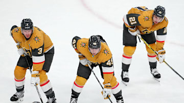 Feb 22, 2025; Las Vegas, Nevada, USA; Vegas Golden Knights defenseman Brayden McNabb (3), Vegas Golden Knights center Ivan Barbashev (49), and Vegas Golden Knights center Brett Howden (21) await a face-off against the Vancouver Canucks during the third period at T-Mobile Arena. Mandatory Credit: Stephen R. Sylvanie-Imagn Images
