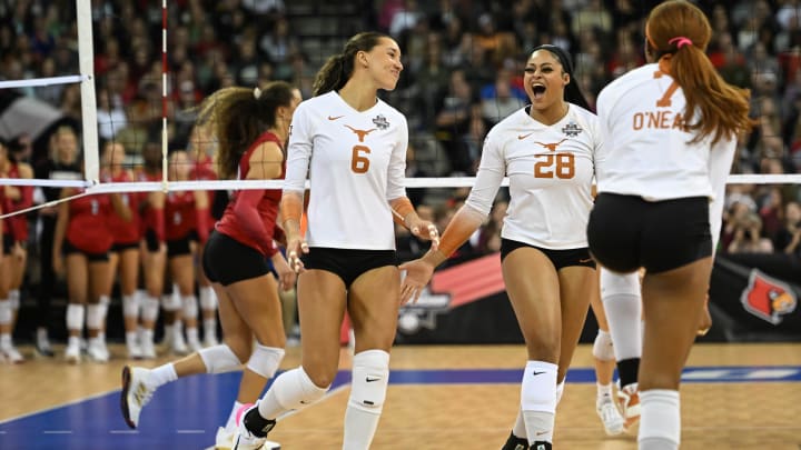 Dec 17, 2022; Omaha, Nebraska, US;  Texas Longhorns middle blocker Kayla Caffey (28) and outside hitter Madisen Skinner (6) celebrate during a match against the Louisville Cardinals at CHI Health Center. Mandatory Credit: Steven Branscombe-USA TODAY Sports