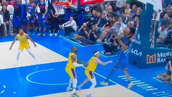 Shai Gilgeous-Alexander takes a shot over Austin Reaves and is awarded a foul. Shai Gilgeous-Alexander takes a shot over Austin Reaves and is awarded a foul.