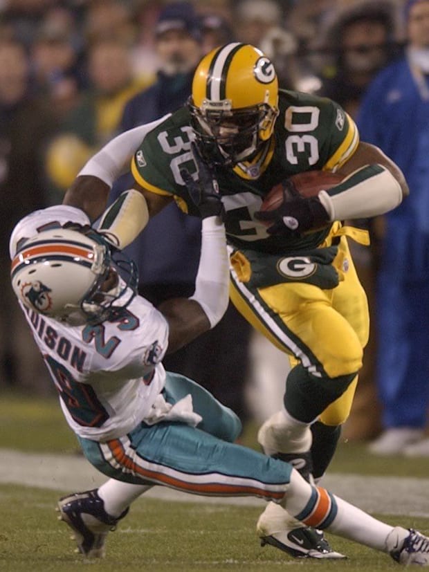 Green Bay Packers Ahman Green runs over a Miami Dolphins cornerback.