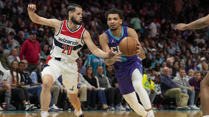 Apr 10, 2022; Charlotte, North Carolina, USA; Charlotte Hornets guard James Bouknight (5) drives to the basket against Washington Wizards forward Jordan Schakel (20) during the second half at Spectrum Center. Mandatory Credit: Jim Dedmon-Imagn Images