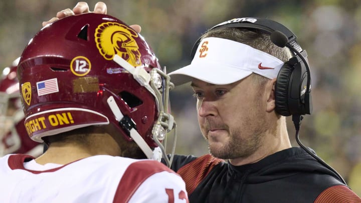 Nov 11, 2023; Eugene, Oregon, USA; USC Trojans head coach Lincoln Riley talks to quarterback Caleb Williams (13) during the first half against the Oregon Ducks at Autzen Stadium. Mandatory Credit: Troy Wayrynen-USA TODAY Sports