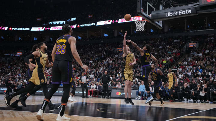 Apr 2, 2024; Toronto, Ontario, CAN;Toronto Raptors forward Kelly Olynyk (41) drives to the basket as Los Angeles Lakers guard Max Christie (10) tries to defend during the fourth quarter at Scotiabank Arena. Mandatory Credit: Nick Turchiaro-USA TODAY Sports