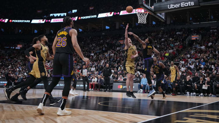 Apr 2, 2024; Toronto, Ontario, CAN;Toronto Raptors forward Kelly Olynyk (41) drives to the basket as Los Angeles Lakers guard Max Christie (10) tries to defend during the fourth quarter at Scotiabank Arena. Mandatory Credit: Nick Turchiaro-USA TODAY Sports