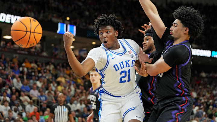 Mar 21, 2026; Greenville, SC, USA; Duke Blue Devils center Patrick Ngongba (21) loses the ball against Texas Christian University Horned Frogs forward David Punch (15) during the second half during a second round game of the men's 2026 NCAA Tournament at Bon Secours Wellness Arena. Mandatory Credit: Bob Donnan-Imagn Images