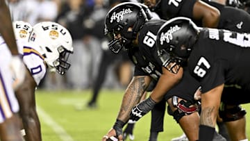 Oct 26, 2024; College Station, Texas, USA; Texas A&M Aggies offensive lineman Kolinu'u Faaiu (61) sets the ball in the fourth quarter against the LSU Tigers at Kyle Field. Mandatory Credit: Maria Lysaker-Imagn Images. 