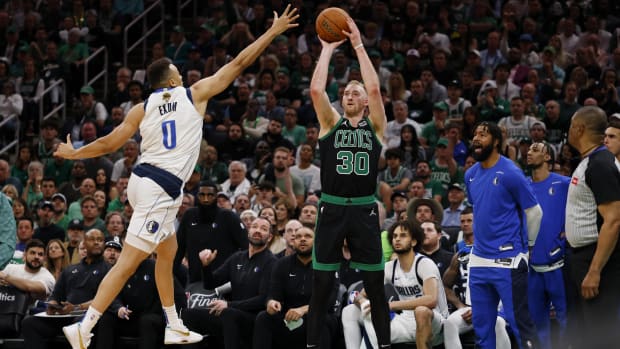 Boston Celtics forward Sam Hauser (30) shoots the ball against Dallas Mavericks guard Dante Exum.