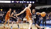 Xavier Musketeers guard Dayvion McKnight drives to the basket defended by Texas Longhorns guard Chendall Weaver