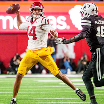 Jayden Maiava looks to pass against Dasan McCullough during the fourth quarter.